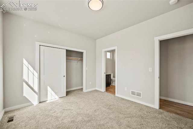 unfurnished bedroom featuring baseboards, a closet, visible vents, and carpet flooring