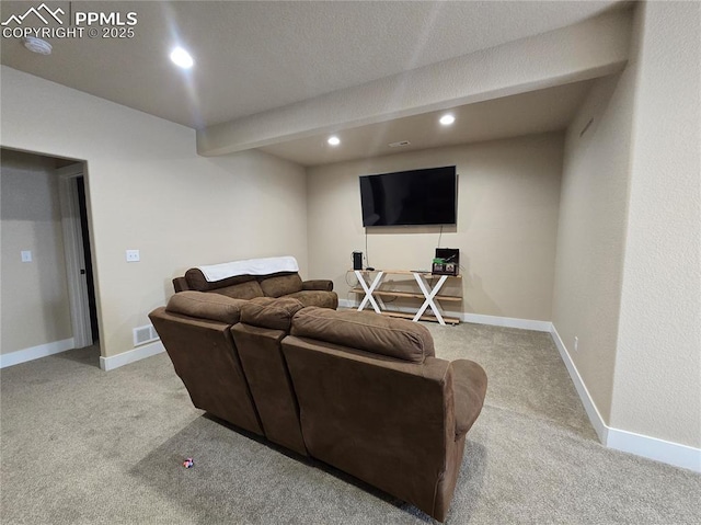 carpeted living room with beamed ceiling