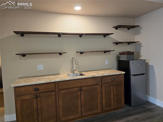 kitchen with sink, stainless steel fridge, and dark hardwood / wood-style flooring