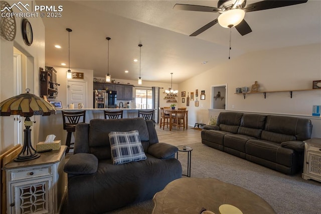 living room with ceiling fan and vaulted ceiling