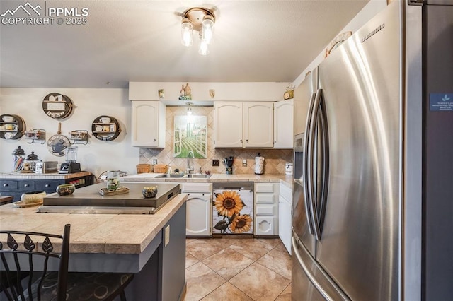 kitchen with tasteful backsplash, stainless steel appliances, sink, and white cabinets