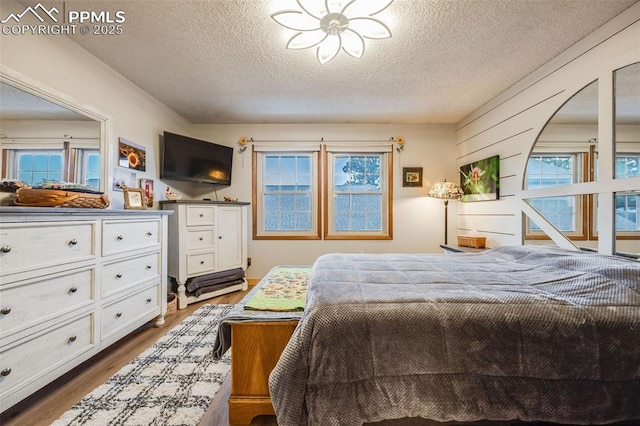 bedroom featuring wood-type flooring and a textured ceiling