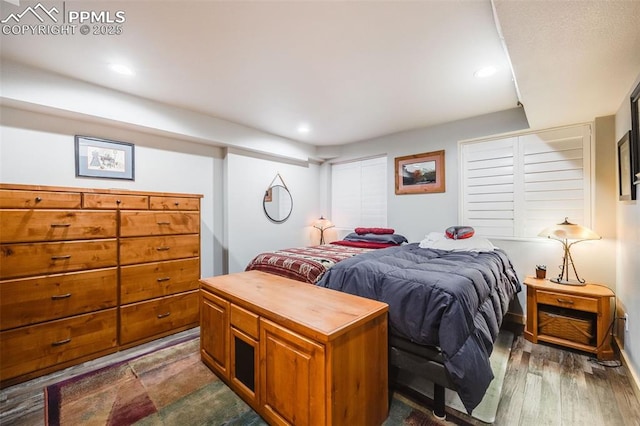 bedroom with dark hardwood / wood-style flooring