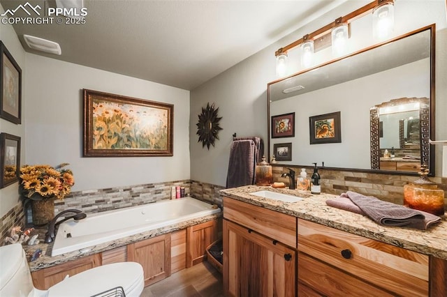 bathroom with vanity and a washtub