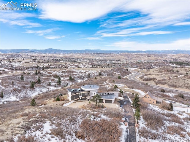 snowy aerial view featuring a mountain view