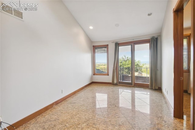 unfurnished room with vaulted ceiling