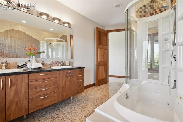 bathroom featuring decorative backsplash, vanity, and independent shower and bath