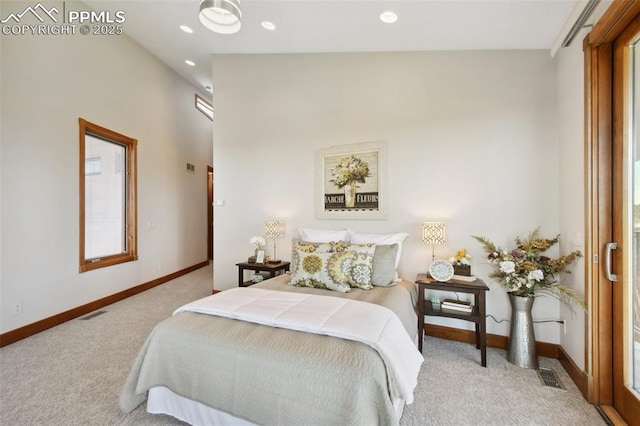 bedroom featuring multiple windows and light colored carpet