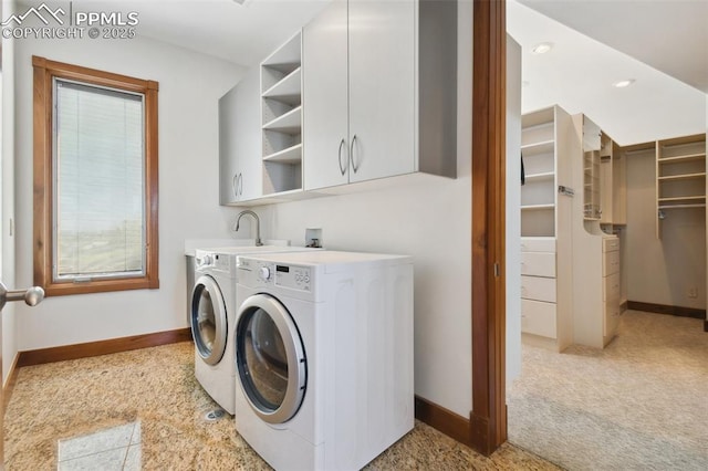 laundry room with sink, washer and dryer, light carpet, and cabinets