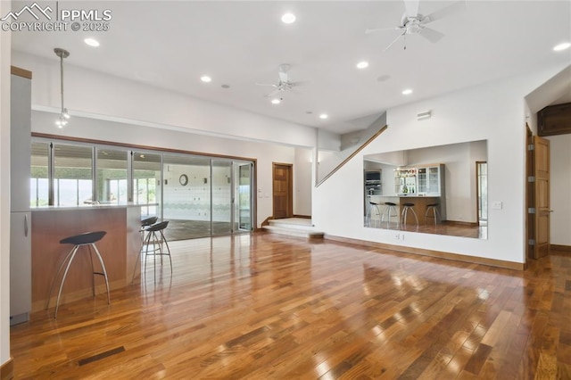 spare room with hardwood / wood-style floors and ceiling fan