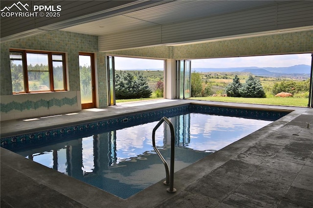 view of swimming pool with a mountain view