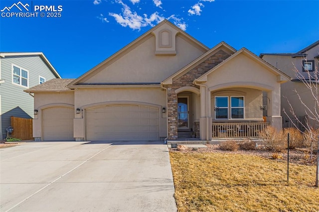 view of front of house with driveway, stone siding, an attached garage, a porch, and stucco siding