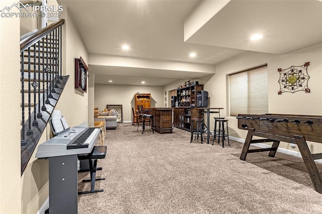 rec room with carpet floors, recessed lighting, baseboards, and a dry bar