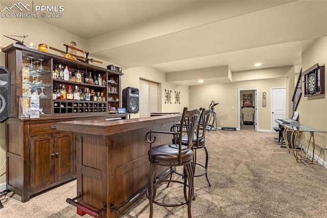 bar with light carpet, baseboards, a dry bar, and recessed lighting