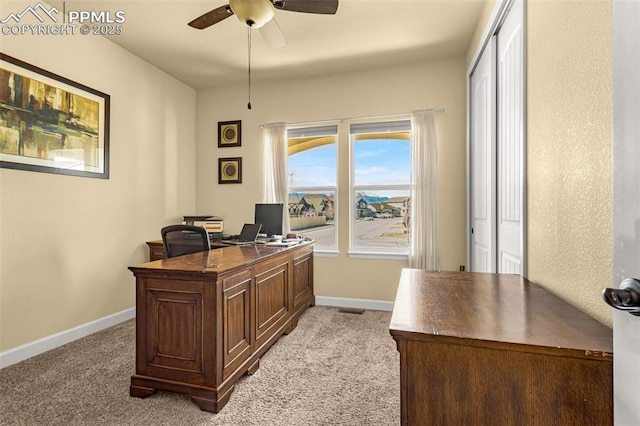 office with visible vents, baseboards, a ceiling fan, and light colored carpet