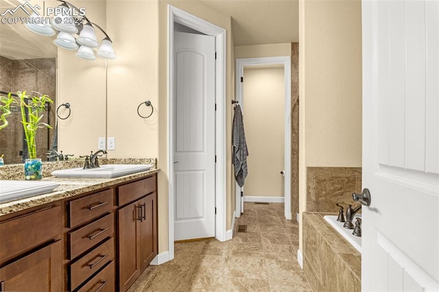 bathroom featuring a garden tub and vanity