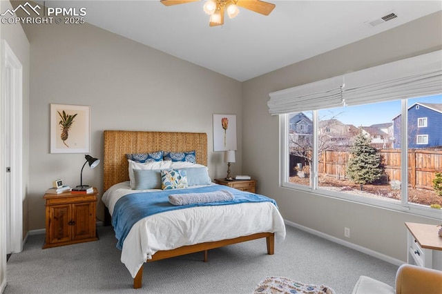 bedroom featuring vaulted ceiling, light colored carpet, and ceiling fan