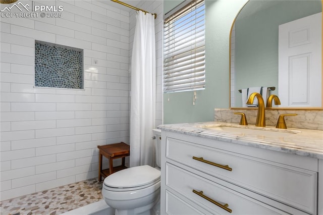 bathroom with vanity, a shower with curtain, and toilet