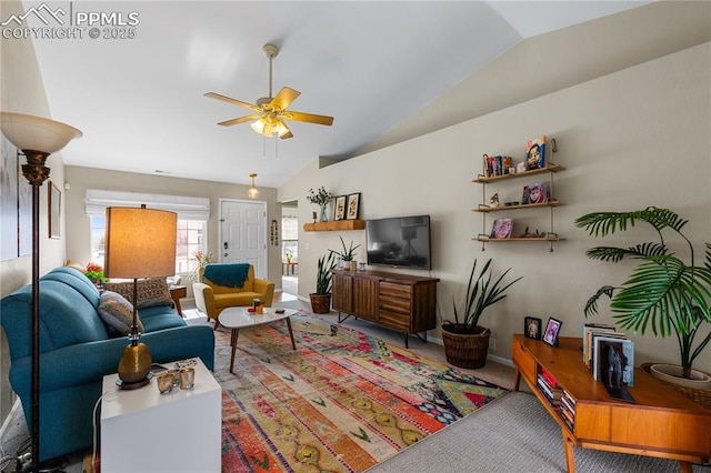 living room with ceiling fan, vaulted ceiling, and carpet