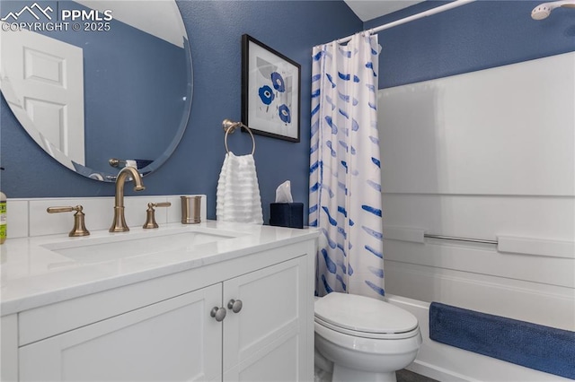 full bathroom featuring vanity, toilet, and shower / tub combo