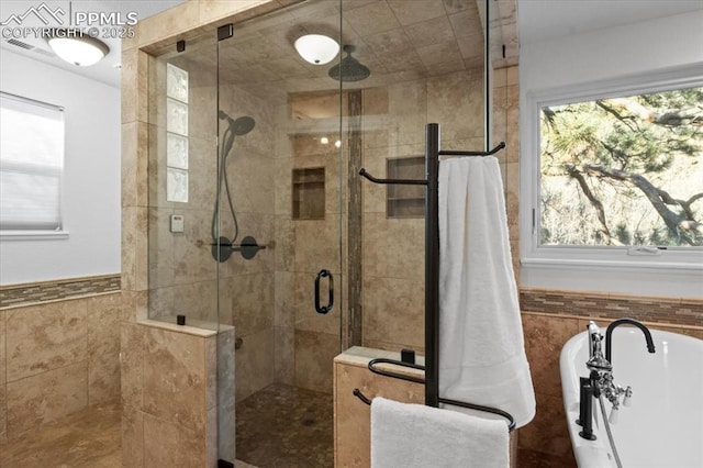 bathroom featuring tile walls and separate shower and tub