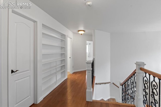 hall featuring dark hardwood / wood-style floors and built in shelves