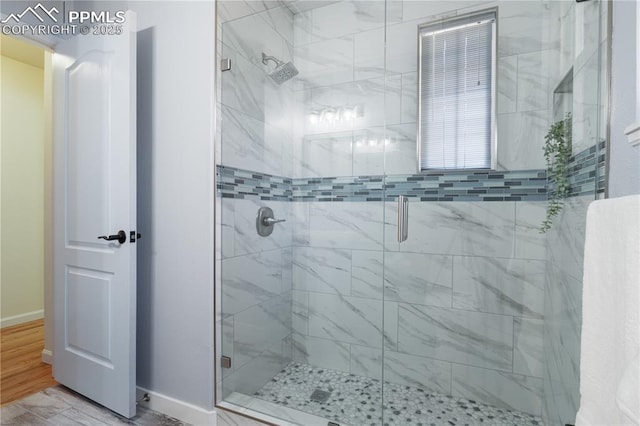 bathroom featuring a shower with door