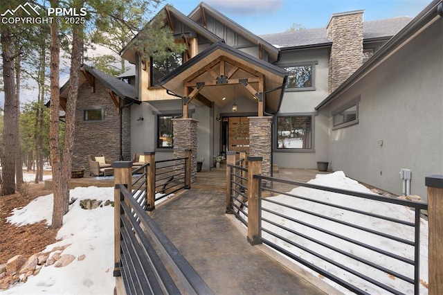 view of snow covered property entrance