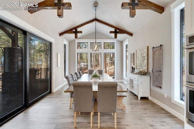 dining area featuring ceiling fan, light hardwood / wood-style flooring, high vaulted ceiling, and beamed ceiling