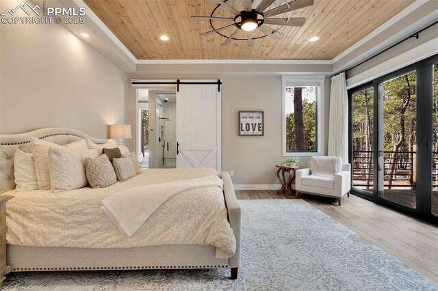 bedroom featuring hardwood / wood-style flooring, a barn door, access to outside, and wooden ceiling