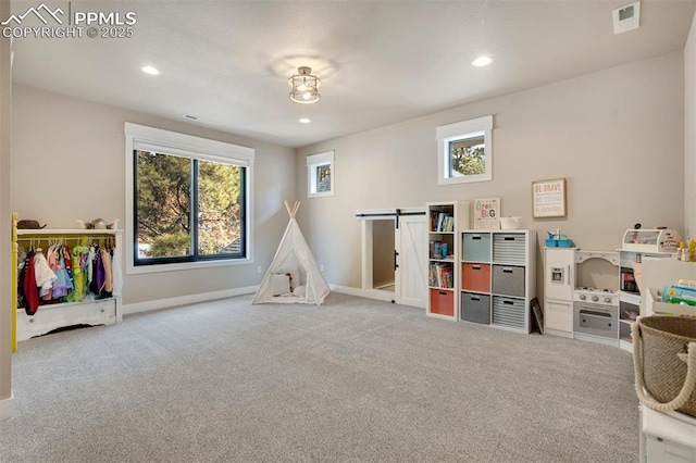 rec room with a wealth of natural light and light colored carpet