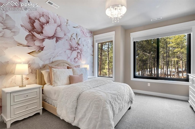 bedroom featuring a notable chandelier and carpet flooring