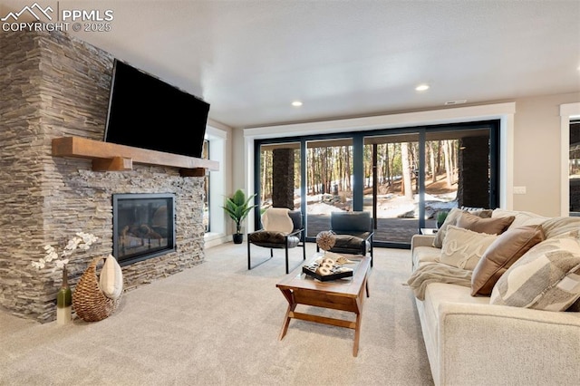 living room with light colored carpet and a fireplace