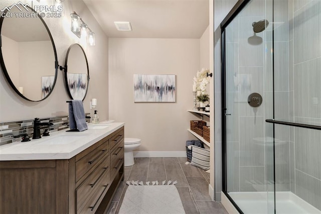 bathroom with vanity, backsplash, toilet, and walk in shower