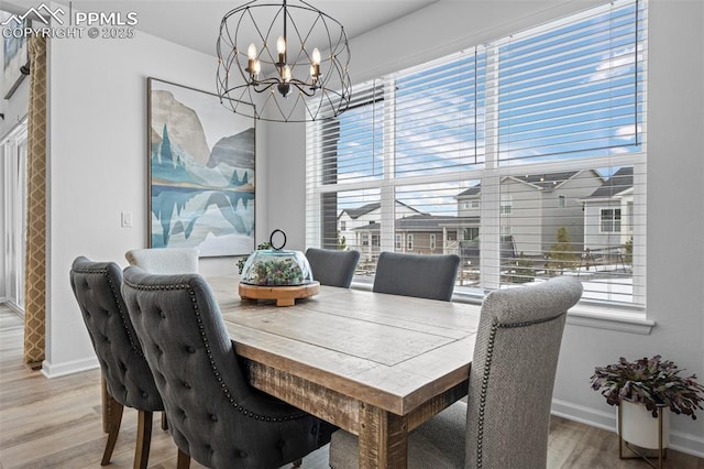 dining area featuring hardwood / wood-style flooring and a notable chandelier