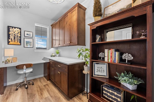 office area featuring built in desk and light hardwood / wood-style floors