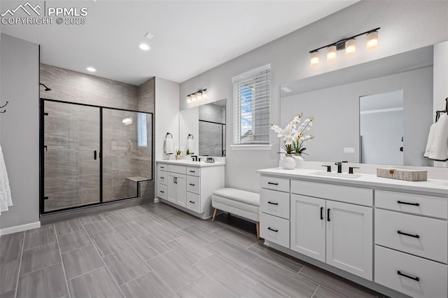 bathroom with vanity and a shower with shower door