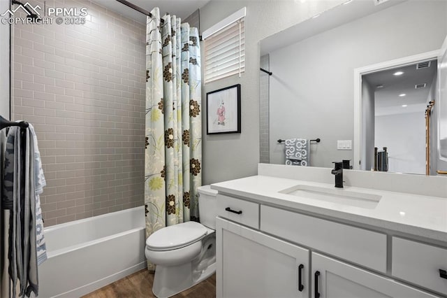 full bathroom with vanity, toilet, hardwood / wood-style floors, and shower / bath combo with shower curtain