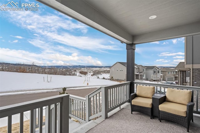 view of snow covered back of property