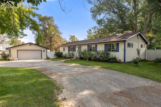 ranch-style house with a garage, an outdoor structure, and a front lawn