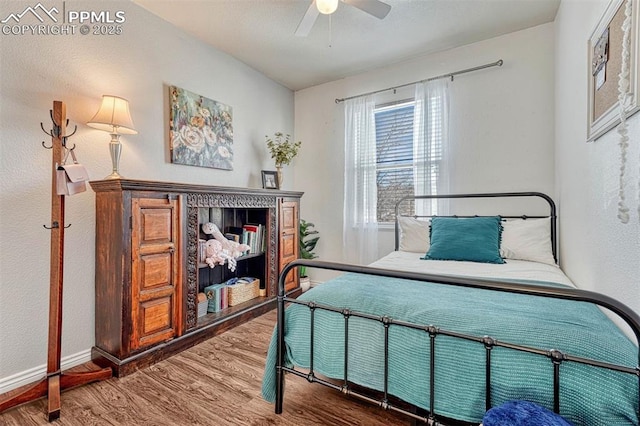 bedroom with hardwood / wood-style flooring and ceiling fan