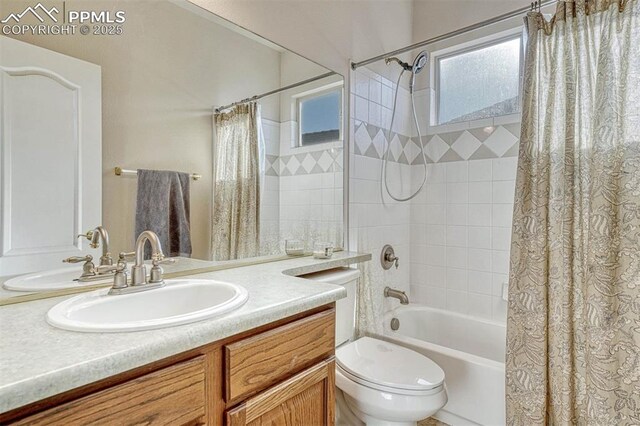 full bathroom with vanity, shower / bath combo, and toilet