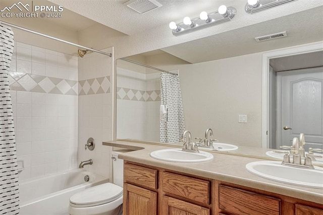 full bathroom featuring vanity, shower / bath combination with curtain, toilet, and a textured ceiling