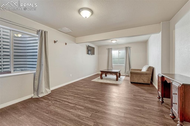 unfurnished room featuring dark hardwood / wood-style floors and a textured ceiling