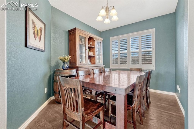 dining room with wood-type flooring and a chandelier