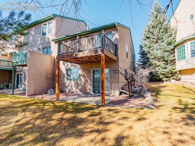 back of property with a yard and a patio area