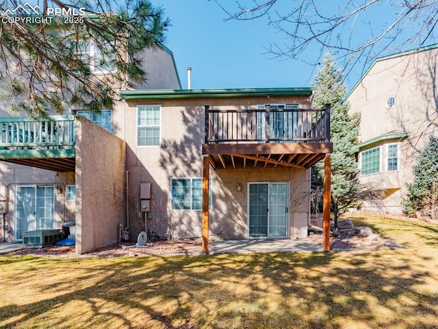 rear view of house featuring a yard and a patio