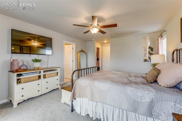 carpeted bedroom with a spacious closet and ceiling fan