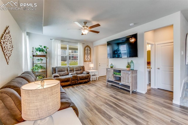 living room with ceiling fan and hardwood / wood-style floors