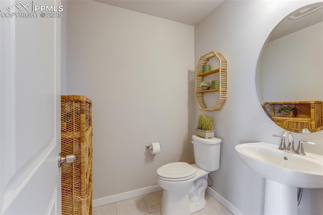 bathroom with sink, tile patterned floors, and toilet